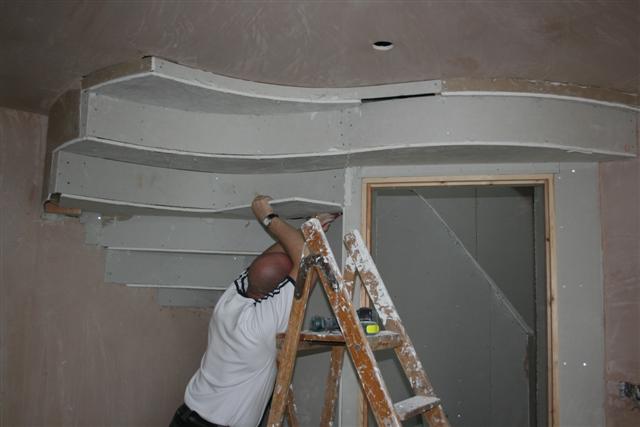 curved plaster under stairs
